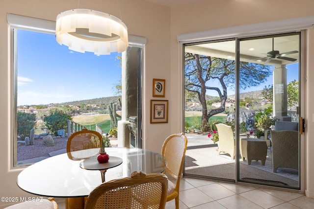 dining room with light tile patterned flooring and ceiling fan