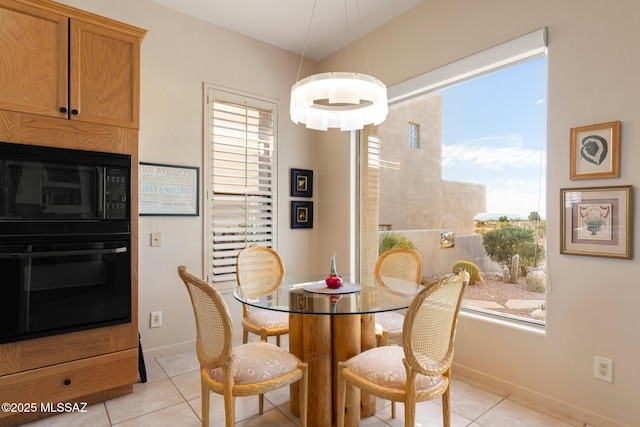 dining area featuring light tile patterned floors and baseboards