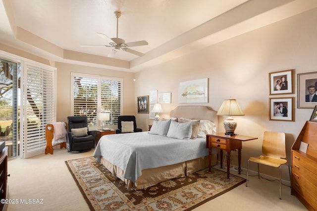 bedroom featuring baseboards, a raised ceiling, a ceiling fan, carpet, and access to outside