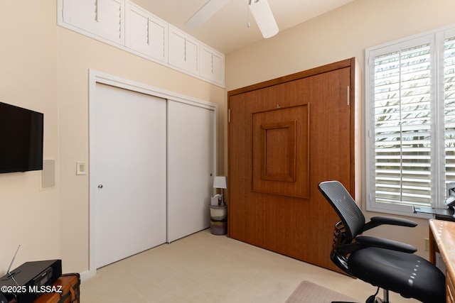 office space with ceiling fan and light colored carpet