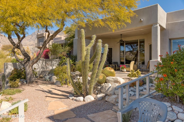 exterior space with a patio, fence, a ceiling fan, and stucco siding