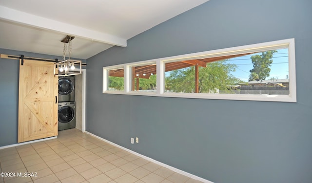 interior space with lofted ceiling with beams, stacked washing maching and dryer, a barn door, and light tile patterned floors