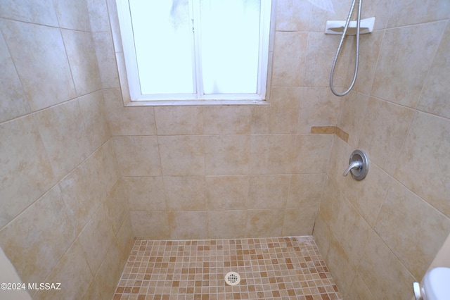 bathroom with a tile shower