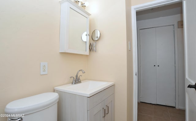 bathroom featuring tile patterned floors, vanity, and toilet