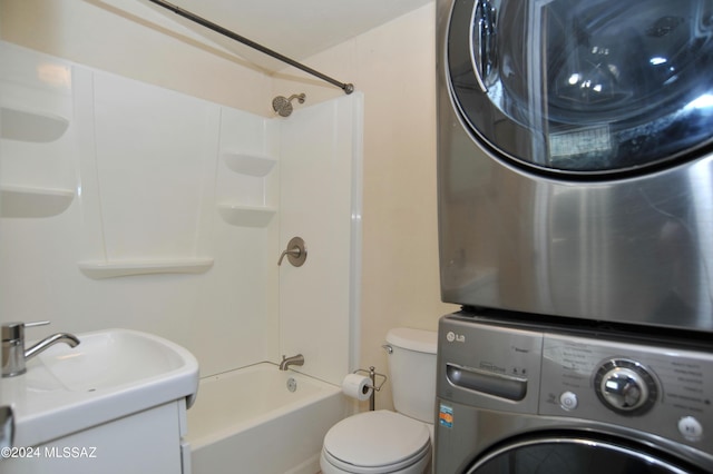 full bathroom with toilet, stacked washer / dryer, bathtub / shower combination, and vanity