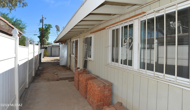 view of property exterior with a storage shed