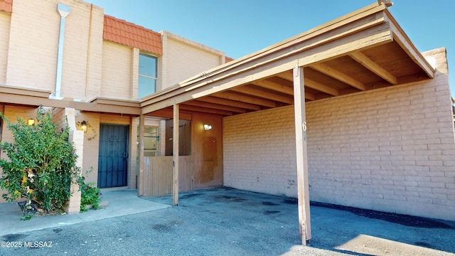 property entrance featuring a carport