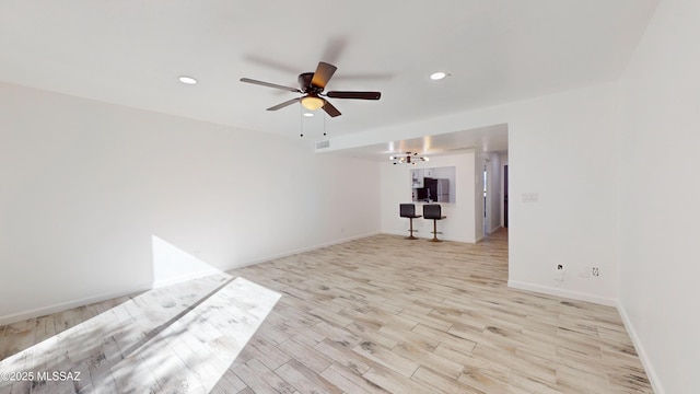 unfurnished room featuring ceiling fan and light wood-type flooring