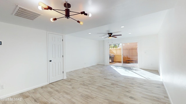 empty room with ceiling fan and light hardwood / wood-style floors