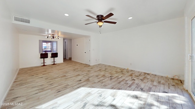 empty room featuring ceiling fan and light wood-type flooring