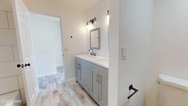 bathroom with vanity, hardwood / wood-style floors, and toilet