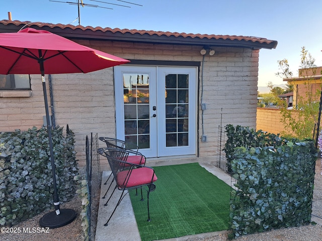 exterior entry at dusk featuring french doors