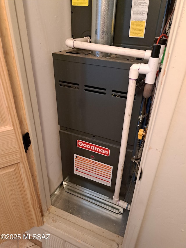 utility room featuring heating unit