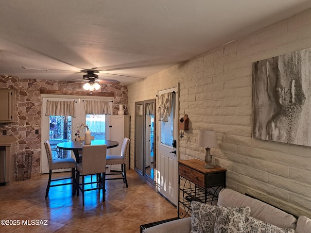 tiled dining space featuring ceiling fan