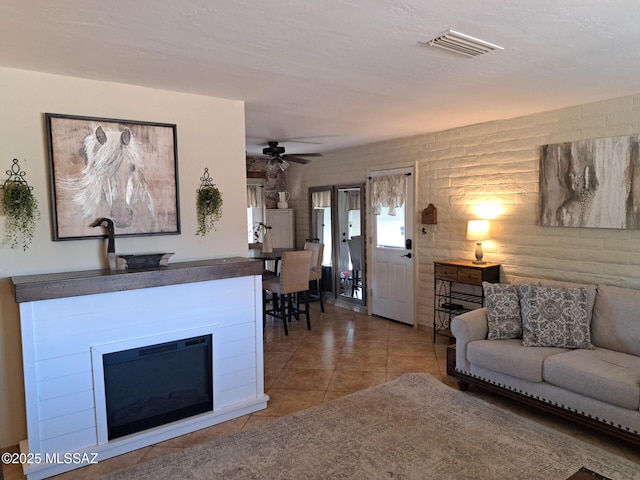 tiled living room featuring ceiling fan