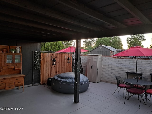 view of patio / terrace featuring a storage unit