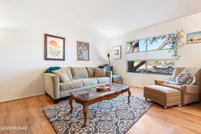 living room featuring vaulted ceiling and wood-type flooring