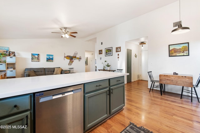 kitchen featuring pendant lighting, lofted ceiling, ceiling fan, light hardwood / wood-style floors, and stainless steel dishwasher