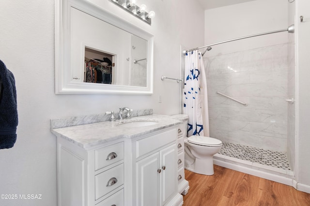 bathroom with vanity, hardwood / wood-style floors, curtained shower, and toilet