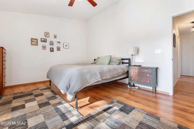 bedroom with hardwood / wood-style floors and ceiling fan