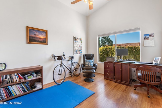 office with ceiling fan, high vaulted ceiling, and light wood-type flooring