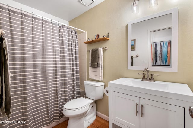 bathroom featuring vanity, wood-type flooring, and toilet