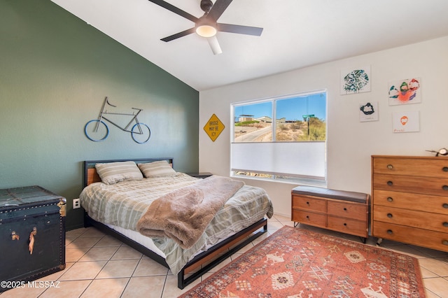 bedroom featuring lofted ceiling, ceiling fan, and light tile patterned flooring