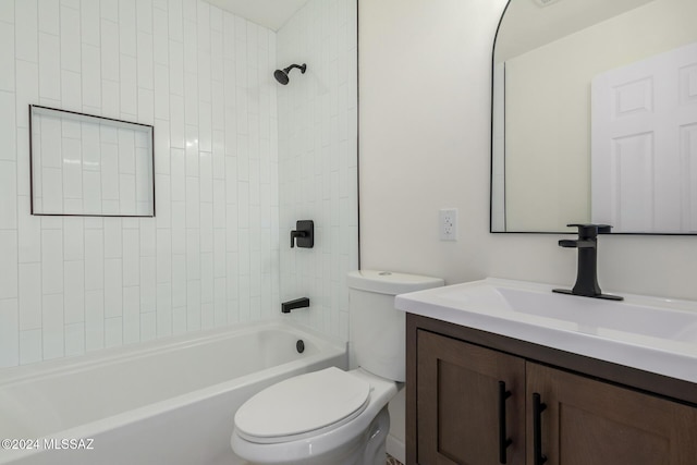 full bathroom with tiled shower / bath, vanity, and toilet