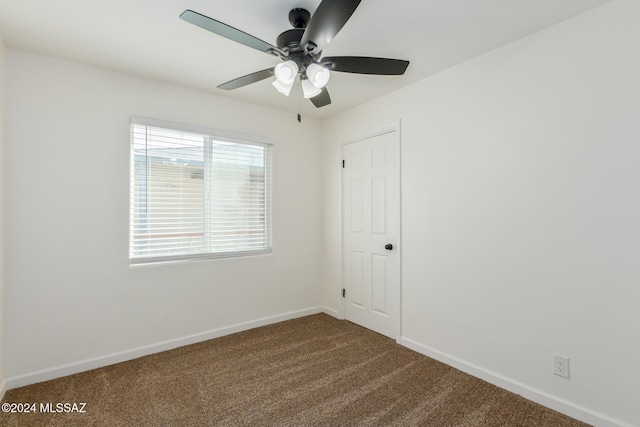 carpeted empty room featuring ceiling fan