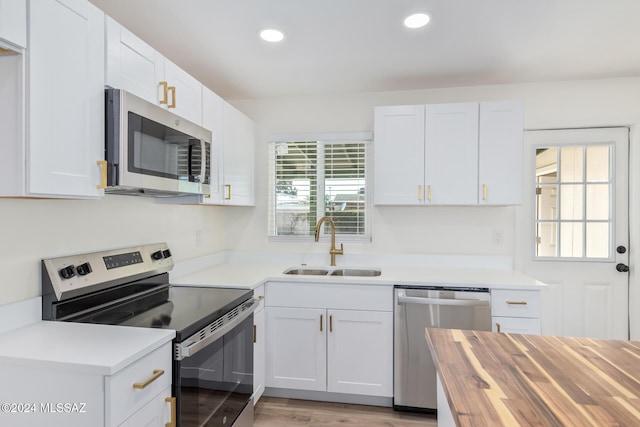 kitchen with appliances with stainless steel finishes and white cabinets