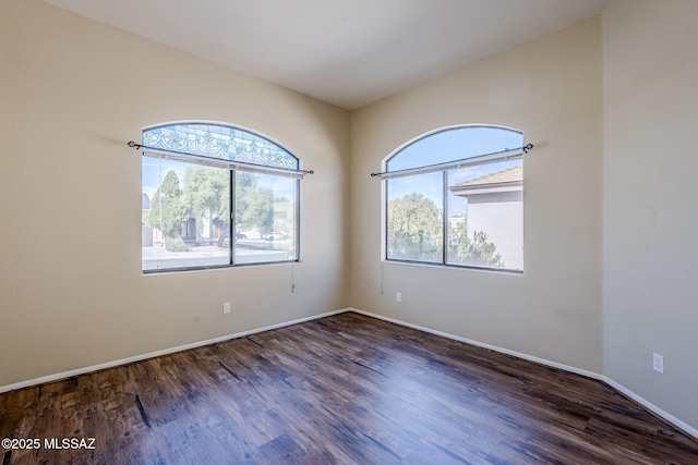 empty room featuring dark wood-type flooring