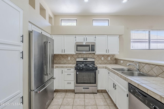 kitchen featuring white cabinetry, appliances with stainless steel finishes, and sink