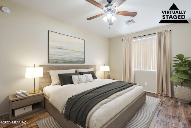 bedroom with wood-type flooring and ceiling fan