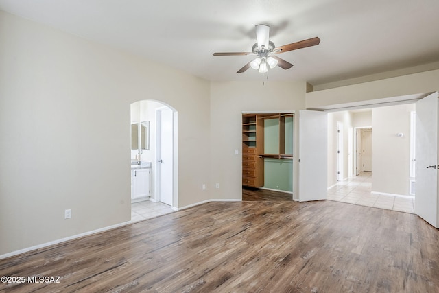 empty room featuring ceiling fan and light wood-type flooring