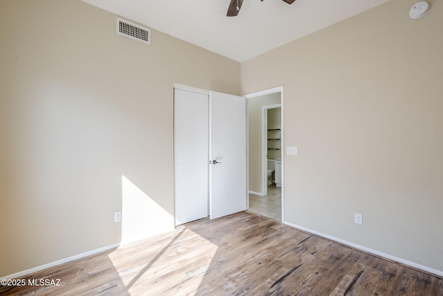 unfurnished bedroom featuring ceiling fan and light wood-type flooring