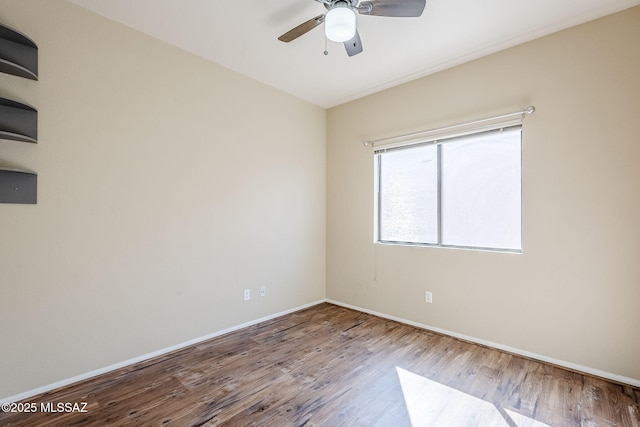 spare room with hardwood / wood-style flooring and ceiling fan