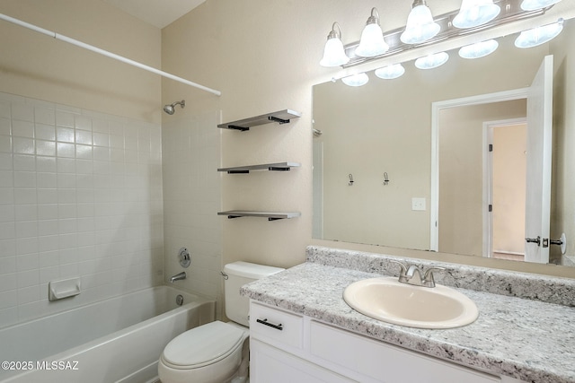 full bathroom with tiled shower / bath, vanity, and toilet