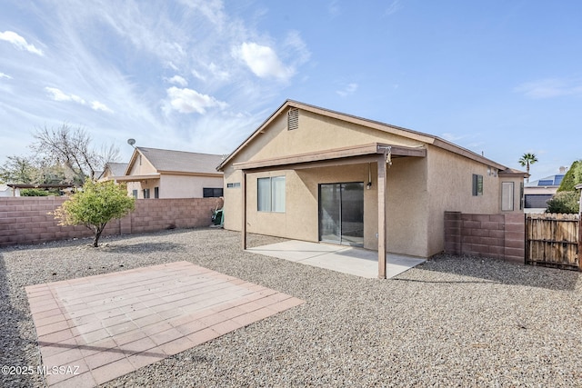 back of property with a patio