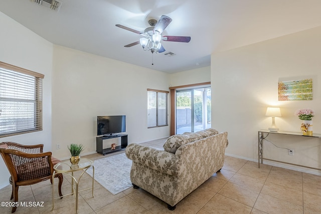 tiled living room with ceiling fan