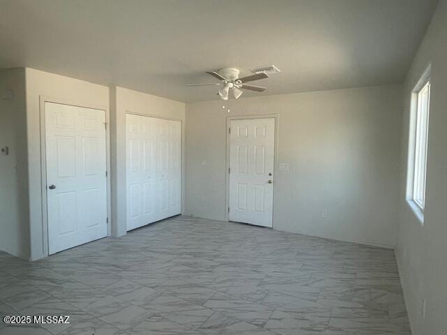 2221 S Sahuara Ave, Tucson, AZ 85711 - interior space with ceiling fan, visible vents, multiple windows, and marble finish floor