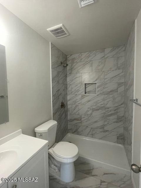 2221 S Sahuara Ave, Tucson, AZ 85711 - bathroom with visible vents, vanity, marble finish floor, toilet, and a tile shower