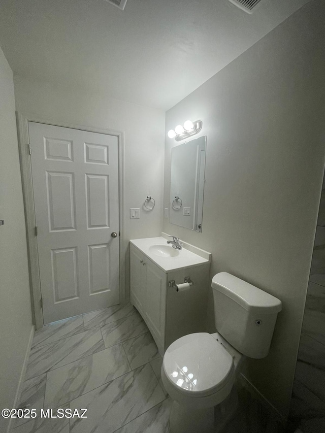 2221 S Sahuara Ave, Tucson, AZ 85711 - bathroom with toilet, marble finish floor, and vanity