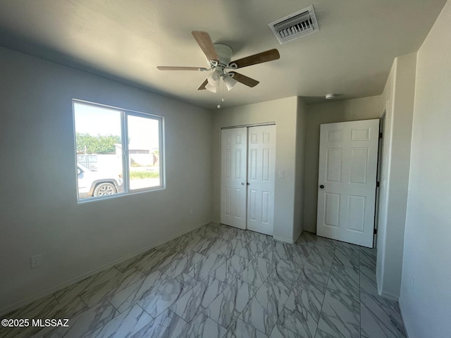2221 S Sahuara Ave, Tucson, AZ 85711 - unfurnished bedroom with ceiling fan, visible vents, baseboards, a closet, and marble finish floor
