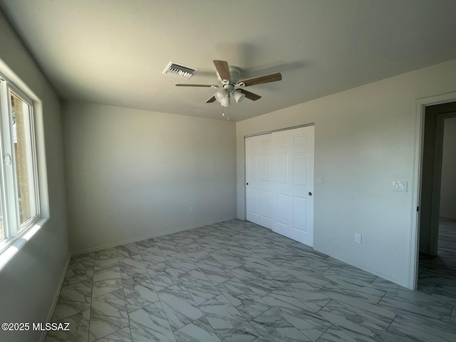 2221 S Sahuara Ave, Tucson, AZ 85711 - unfurnished bedroom with baseboards, marble finish floor, visible vents, and a closet