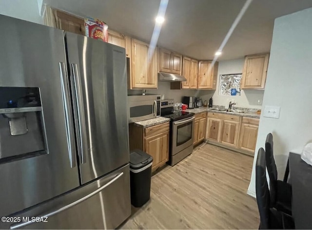 2221 S Sahuara Ave, Tucson, AZ 85711 - kitchen with appliances with stainless steel finishes, a sink, light wood finished floors, light brown cabinets, and under cabinet range hood