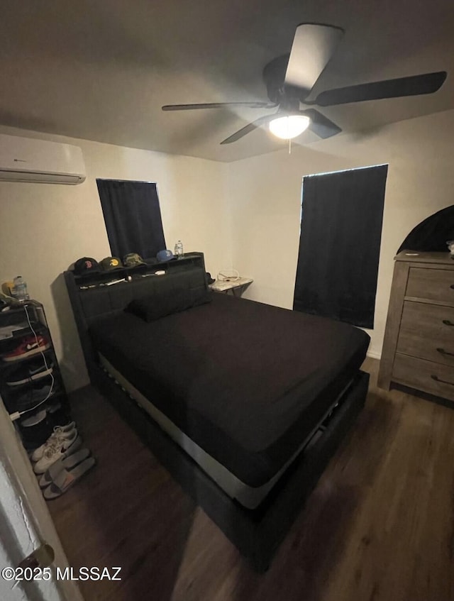 2221 S Sahuara Ave, Tucson, AZ 85711 - bedroom featuring an AC wall unit, ceiling fan, and wood finished floors
