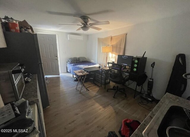 2221 S Sahuara Ave, Tucson, AZ 85711 - bedroom with a wall unit AC, wood finished floors, and ceiling fan