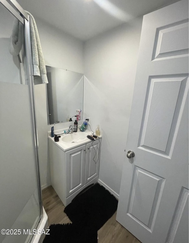 2221 S Sahuara Ave, Tucson, AZ 85711 - bathroom with vanity, wood finished floors, and a shower stall