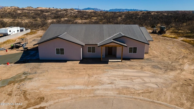 view of front facade featuring a mountain view and a patio area