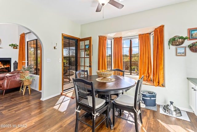 dining space with dark wood-type flooring and ceiling fan